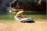 A rafting guide resting.  Her clientele seem to be missing...